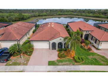 Aerial view of single Gathering home with red tile roof at 23590 Copperleaf Dr, Venice, FL 34293