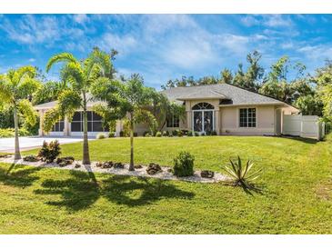 One-story home with palm trees and lush lawn at 16093 Hillsborough Blvd, Port Charlotte, FL 33954