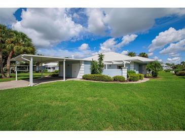 Single-story condo with carport and manicured landscaping at 451 Wexford Cir, Venice, FL 34293