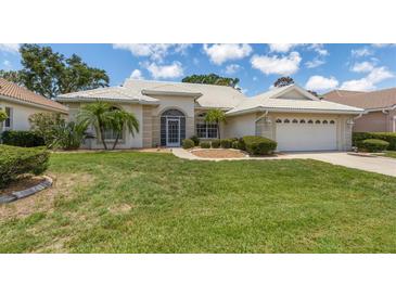 Single story home with tile roof and two car garage at 1136 Highland Greens Dr, Venice, FL 34285