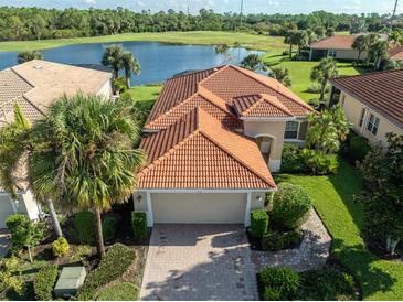 Single-Gathering home with tile roof and attached garage; water view at 126 Cipriani Way, North Venice, FL 34275