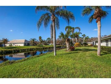 Property backs up to a peaceful canal with lush landscaping at 172 Southampton Pl # 346, Venice, FL 34293