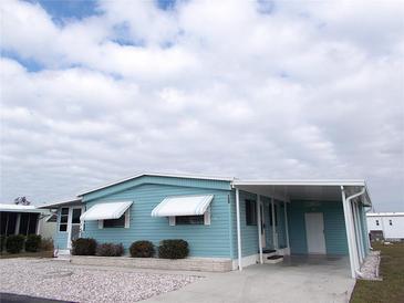 Charming single-story home with a covered carport and well-maintained landscaping under a cloudy sky at 359 Longwood Dr, Venice, FL 34285