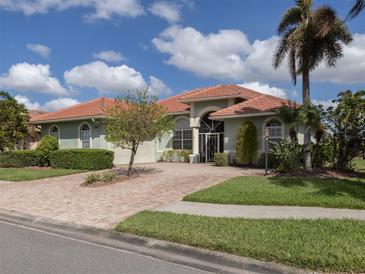 House exterior featuring a brick driveway and lush landscaping at 4245 Via Del Villetti Dr, Venice, FL 34293