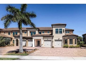 Beautiful 2 story townhome with 2 car garage, landscaped grounds, and brick pavers at 10055 Crooked Creek Dr # 103, Venice, FL 34293