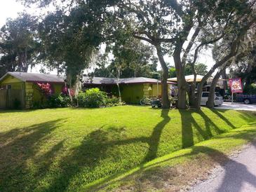 Charming ranch home with lush lawn and mature trees at 231 Victoria Rd, Venice, FL 34293