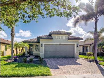 Single-story home with a two-car garage and landscaped front yard at 19140 Mangieri St, Venice, FL 34293