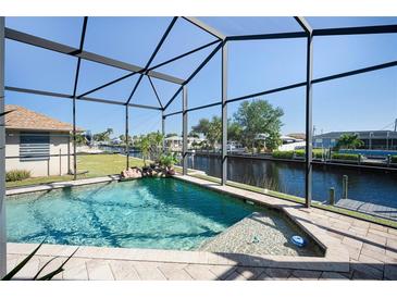 Relaxing pool area with canal view and screened enclosure at 3390 Dover Dr, Punta Gorda, FL 33983