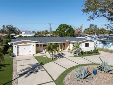 A beautiful home featuring a lush yard, fresh white paint, a new roof and a lovely front yard with palms at 510 Harbor S Dr, Venice, FL 34285