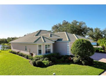 Beautiful one-story home with tile roof, landscaping, and two-car garage at 11394 Dancing River Dr, Venice, FL 34292