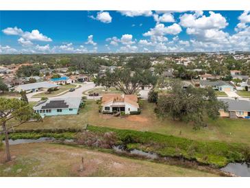 Wide aerial view of the house and neighborhood, highlighting its location near a waterway at 1439 Strada D Argento, Venice, FL 34292