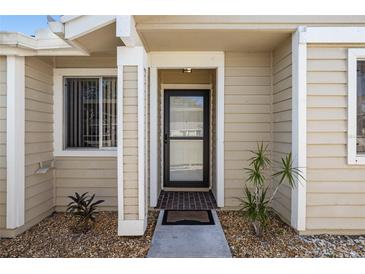 Inviting front entrance with a dark door and brick walkway at 3015 Seawind Cir # 12A, Venice, FL 34293