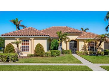 Beautiful one-story home with tile roof, lush landscaping, and a welcoming entryway at 995 Chickadee Dr, Venice, FL 34285