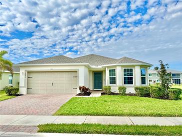 Single story home with light-colored exterior, two-car garage, and well-manicured lawn at 3648 Pebble Ter, Punta Gorda, FL 33980