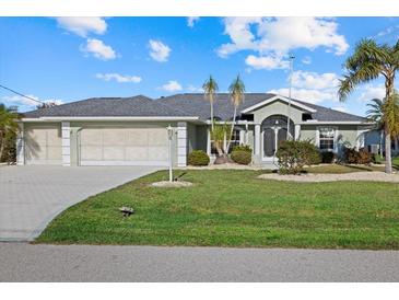 Single-story home with a two-car garage and well-manicured lawn at 52 Fairway Rd, Rotonda West, FL 33947