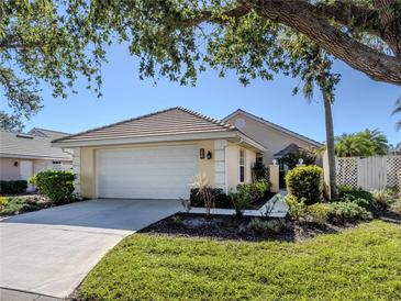 Single-story house with attached garage, landscaping, and a paved driveway at 522 Clubside Cir # 10, Venice, FL 34293