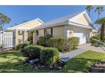 Well-maintained house with a landscaped yard and walkway at 752 Harrington Lake N Dr # 114, Venice, FL 34293