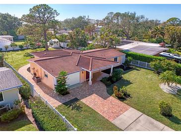 Aerial view of single-Gathering home with red tile roof and spacious yard at 225 Firenze W Ave, Venice, FL 34285