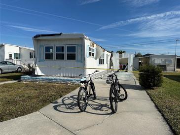 Storm damaged mobile home with yellow caution tape at 231 Inner E Dr, Venice, FL 34285