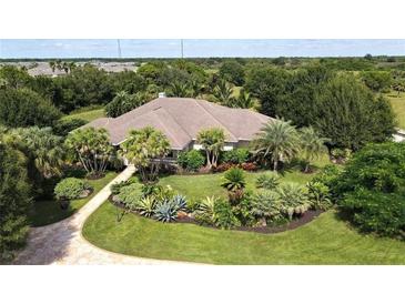 Inviting home with lush landscaping and a paved driveway at 3200 Rowland Dr, Punta Gorda, FL 33980