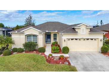 Attractive single-story house with landscaped yard and two-car garage at 4231 Tennyson Way, Venice, FL 34293