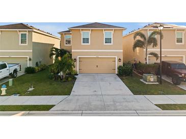 Two-story house with attached garage and landscaped lawn at 4861 Silver Topaz St, Sarasota, FL 34233