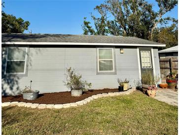 Charming single-story home with a tidy front lawn, mulch bed and well-maintained gray exterior at 2191 Park Rd, Venice, FL 34293