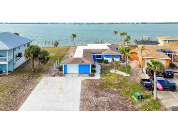 Waterfront home with large lot and detached garage. Spacious yard with potential for expansion at 227 Bahia Vista Dr, Englewood, FL 34223