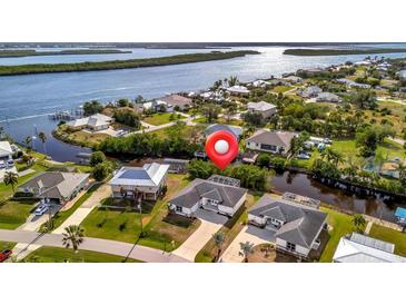 An aerial view shows waterfront homes with well-kept lawns, private docks, and easy access to the river at 3436 Santa Clara Dr, Punta Gorda, FL 33983