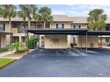 Covered parking spaces for residents in front of the building at 380 Three Lakes Ln # E, Venice, FL 34285