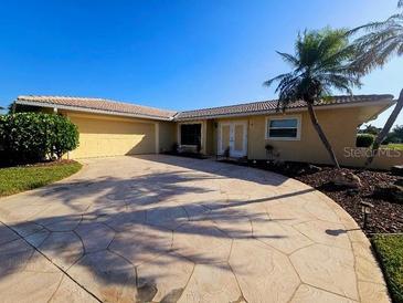Charming single-story home with a well-maintained lawn and mature landscaping at 4 Windsor Dr, Englewood, FL 34223