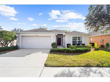 One-story house with a two-car garage and landscaped yard at 5198 Layton Dr, Venice, FL 34293