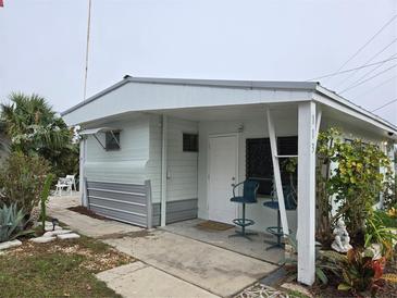 Quaint one-story home with covered entryway and small front yard at 113 B Ravenna N St, Nokomis, FL 34275