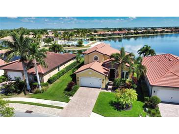 Aerial view of a beautiful house with a lake view and resort-style community at 140 Maraviya Blvd, Nokomis, FL 34275