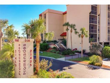 Building exterior with palm trees and parking at 21405 Olean Blvd # 404, Port Charlotte, FL 33952