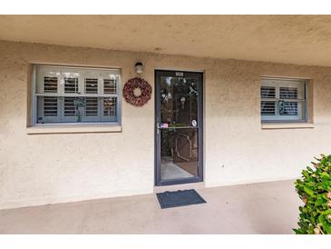 Inviting condo entry with a wreath and neutral color scheme at 2260 Stickney Point Rd # 303, Sarasota, FL 34231