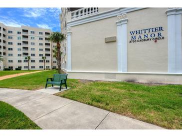 Whittier Manor building exterior, showing landscaping and a walkway at 3730 Cadbury Cir # 400, Venice, FL 34293