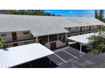 Condo building with parking and covered walkways at 509 Parkdale Mews # 509, Venice, FL 34285