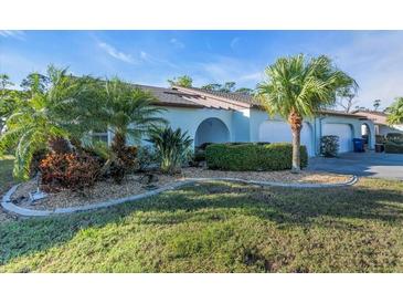 Charming single-story home with lush landscaping and mature palm trees in a well-maintained neighborhood at 507 Foxwood Blvd # 4, Englewood, FL 34223