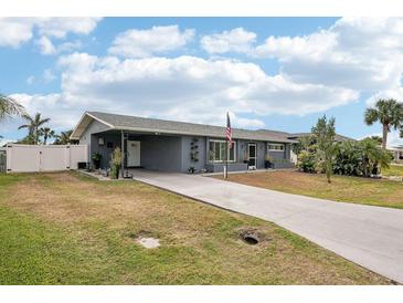 Charming single-story home featuring a spacious driveway and well-maintained landscaping, perfect for suburban living at 4310 Albacore Cir, Port Charlotte, FL 33948