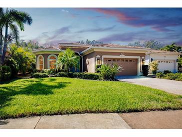 Beautiful single-story home featuring a well-manicured lawn and a two-car garage at 107 Corte Del Rosa, Venice, FL 34285