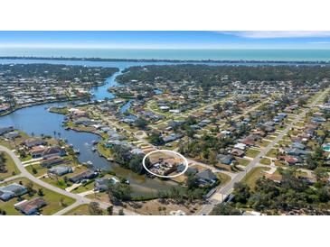 Expansive aerial view of a waterfront community with lush landscaping and a serene coastal backdrop at 1985 Fairview Dr, Englewood, FL 34223