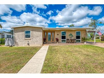 Charming single-story home with a well-maintained lawn and inviting front porch at 6627 Marius Rd, North Port, FL 34287