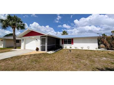 Charming single-story home with a screen door entryway, white exterior, and lush landscaping at 237 Venice East Blvd, Venice, FL 34293
