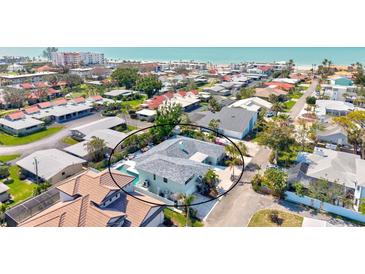 Stunning aerial view of beach house with pool and outdoor seating in a desirable coastal neighborhood at 605 Cornwell On The Gulf, Venice, FL 34285