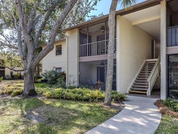 Two story condo featuring screened patios and verdant landscaping offers a tranquil living experience at 748 White Pine Tree Rd # 208, Venice, FL 34285