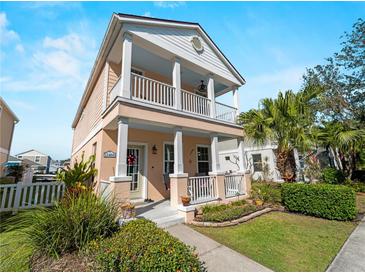 Charming two-story home featuring a double porch, well-manicured lawn, and tropical landscaping at 12468 Shimmering Oak Cir, Venice, FL 34293