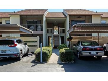 Charming condo exterior features assigned parking, well-maintained landscaping, and inviting stairways to upper units at 630 Bird Bay E Dr # 208, Venice, FL 34285