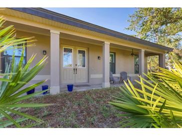 Inviting front porch with stylish columns and double doors welcomes you home at 1115 Gladstone Blvd, Englewood, FL 34223