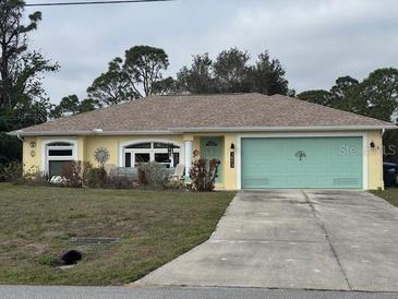 Charming single-story home featuring a bright, yellow facade, light-green garage door and well-maintained front yard at 1893 Amato St, North Port, FL 34291